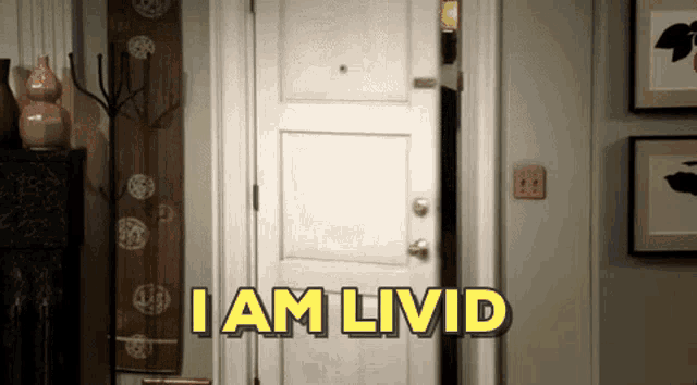 a white door with the words " i am livid " on it