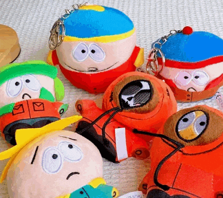 a bunch of south park stuffed toys are laying on a table