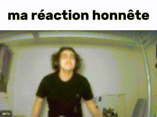 a man in a black shirt is standing in front of a wall with the words `` ma réaction honnete '' written on it .