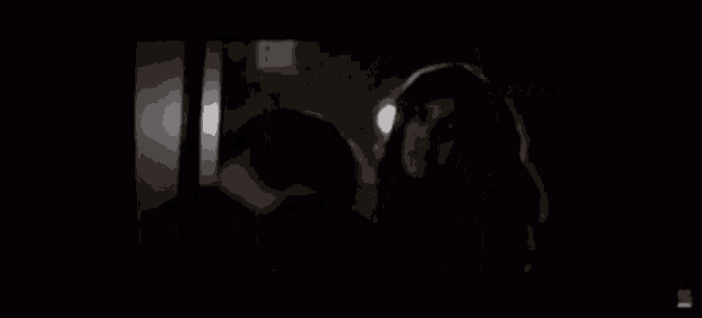 a blurry picture of a person in a hallway with a sign that says ' a ' on it