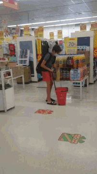a person standing in a store with a sign that says descuento