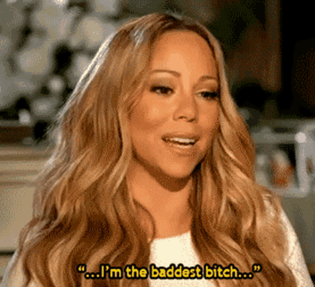 a woman with long blonde hair is saying " i 'm the baddest bitch "