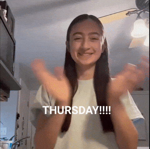 a woman in a white shirt with the word thursday written on it