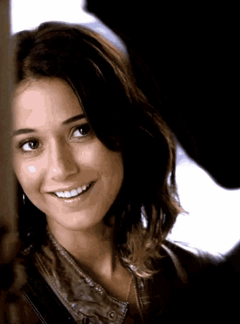 a close up of a woman 's face smiling