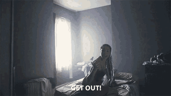 a woman laying on a bed with the words get out written on the bottom