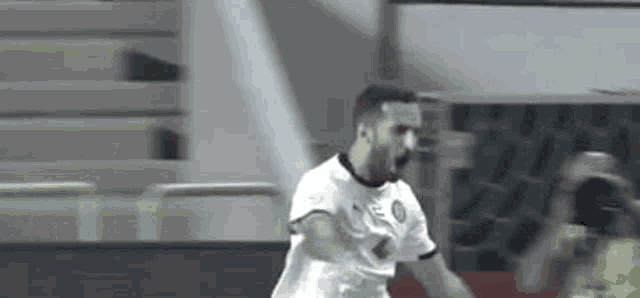 a soccer player is celebrating after scoring a goal during a game .