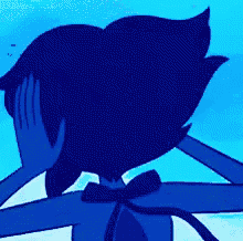 a person is touching a blue cartoon character 's face with a fork .
