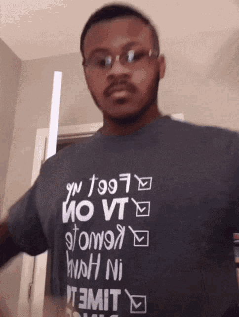 a man wearing glasses and a t-shirt that says no vt on it