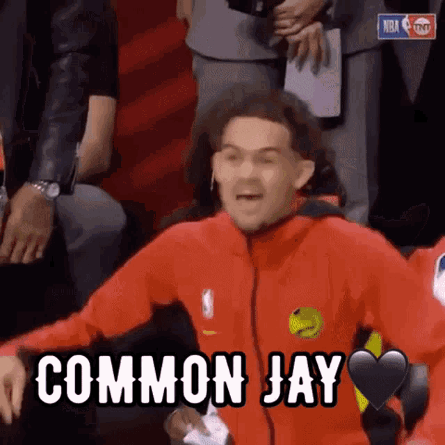 a man in a red jacket with the word common jay on his chest .