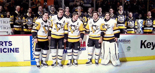 a group of hockey players are posing for a picture in front of a sign that says key