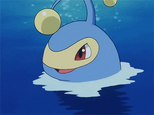 a blue cartoon character is swimming in the ocean