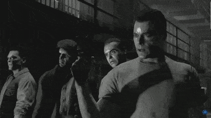a black and white photo of a group of people holding guns