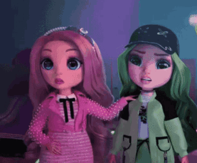 two dolls are standing next to each other with one wearing a hat