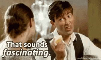 a man and a woman are talking to each other and the man is holding a piece of food .