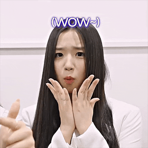 a woman with long black hair is making a surprised face with the words wow written above her head
