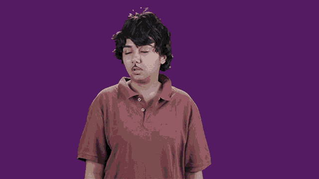 a young man with a mustache is wearing a red shirt