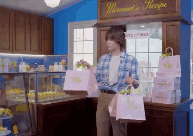a man standing in front of a mermaid 's recipe store
