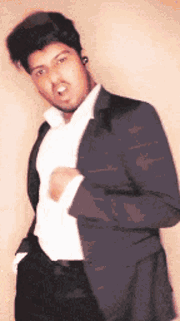 a man in a suit and white shirt is making a face