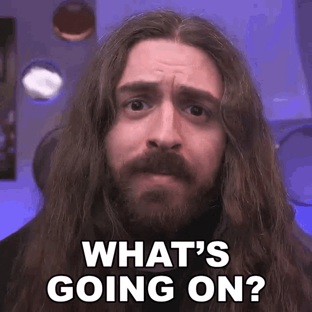 a man with long hair and a beard is asking what 's going on ?