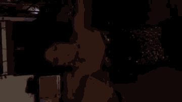 a woman in a black sequined dress is dancing in the dark .