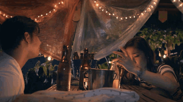 a man and a woman sitting at a table with the words four years ko na siyang mahal and counting above them
