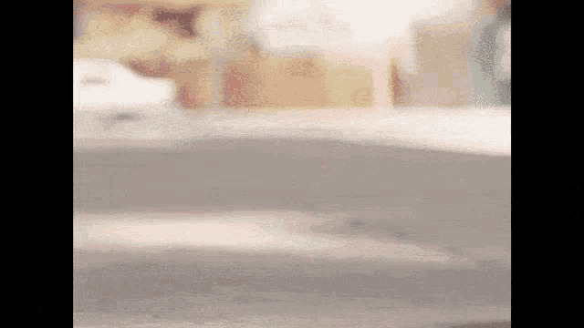 a blurred image of a person standing in front of a counter