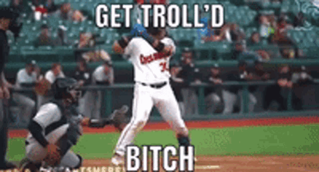 a baseball player is getting ready to hit the ball while a catcher looks on .