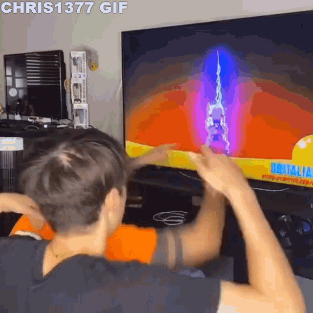a man is playing a video game on a flat screen tv with chris 1377 gif written on the bottom
