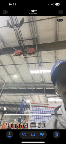 a phone screen shows a picture of a man in a blue hat and says today 9:52 am