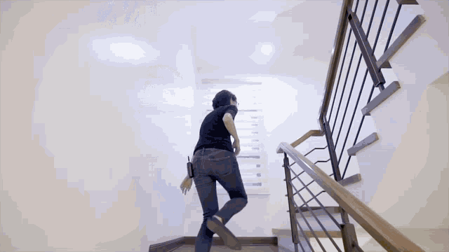 a woman walking down a set of stairs with a railing