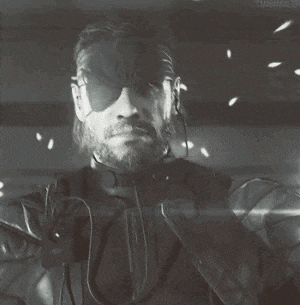 a black and white photo of a man with a beard wearing a blindfold and headphones .