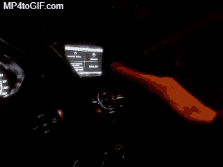 a person is pressing a button on a car dashboard with mp4togif.com in the corner