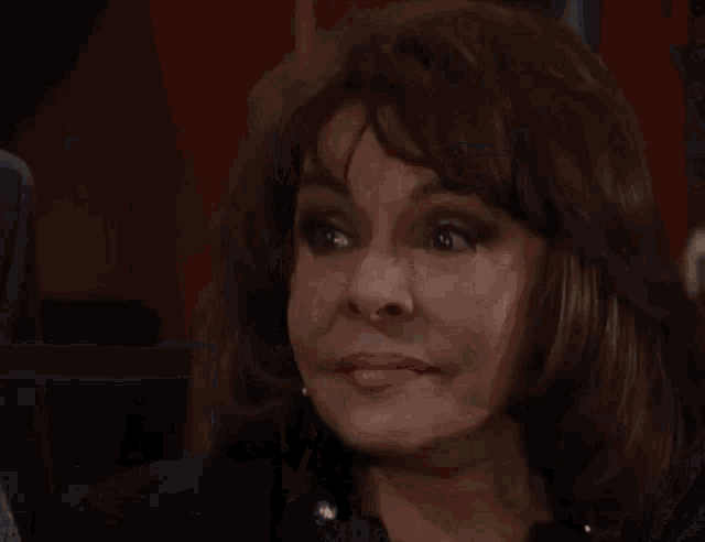 a close up of a woman 's face with her eyes closed