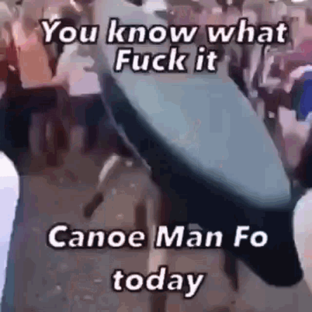 a person is holding a canoe in their hands in front of a crowd of people .