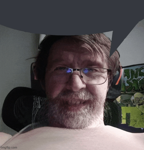 a man with glasses and a beard is smiling in front of a jungle book