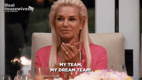 a woman sitting at a table with a real housewives logo on the bottom
