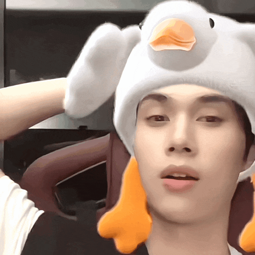 a person wearing a white hat with a duck head on it