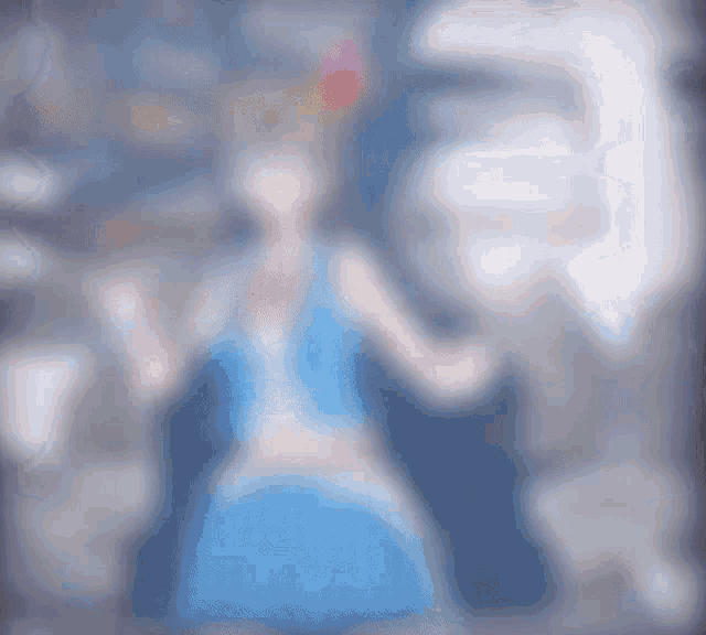 a blurred image of a girl in a blue dress