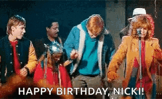 a group of people are dancing on a stage with the words `` happy birthday , nicki '' .