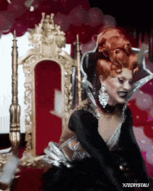 a drag queen is sitting on a throne with the name xtecrystali on the bottom