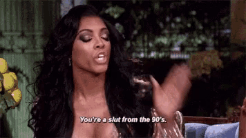 a woman in a very revealing dress is saying `` you 're a slut from the 90s '' .