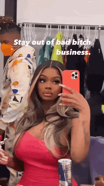 a woman in a pink dress is taking a selfie in front of a mirror with the words stay out of bad bitch business below her