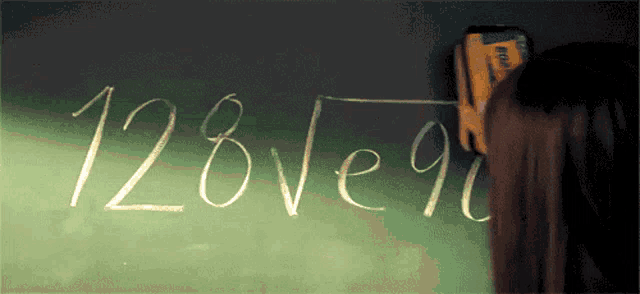 a person is writing on a blackboard that says " 128 ve 90 "