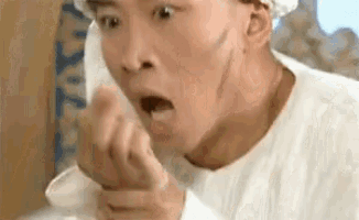 a close up of a man making a funny face with his mouth open .