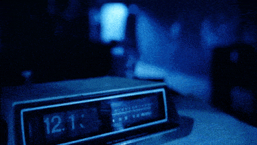a digital clock that says 12:14 on it