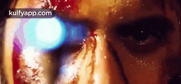 a close up of a person 's face with water coming out of their eyes .