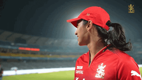 a woman wearing a red hat and a red shirt that says tata capital