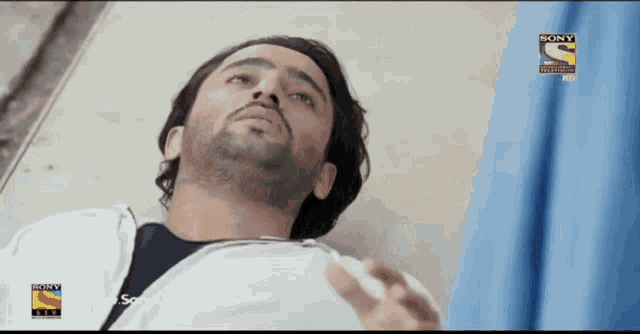 a man is laying in a hospital bed with a sony television logo on the bottom right