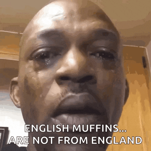 a close up of a man 's face with a caption that says english muffins are not from england