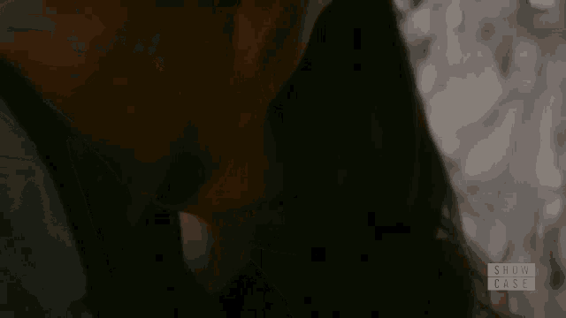 a close up of a man and woman kissing with the words show case below them